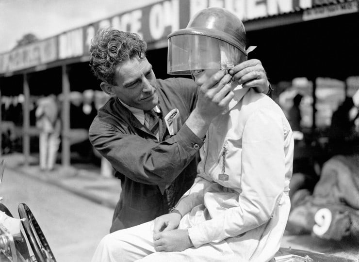 A-Brooklands-mechanic-fastens-the-buckle-on-Miss-Dorothy-Turners-helmet-1937