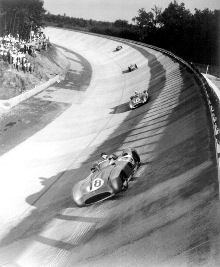 Juan Manuel Fangio leads Stirling Moss, Piero Taruffi, and Karl Kling on the Monza banking at the 1955 Italian Grand Prix