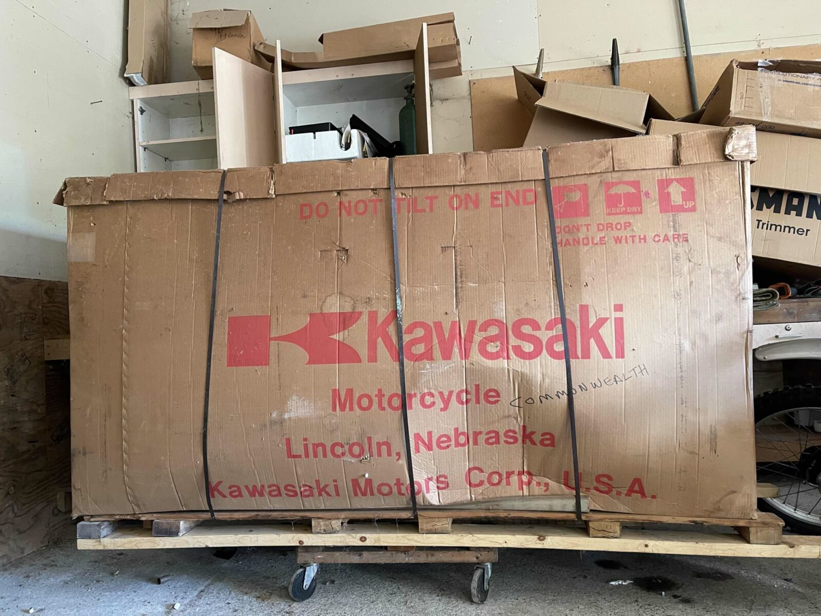 A 1977 Kawasaki KZ400 Deluxe in its original factory crate, showcasing the enduring legacy of classic motorcycles and the precision of early manufacturing techniques.