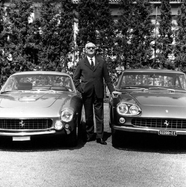 Enzo Ferrari standing with a Ferrari 250 GT Lusso and a Ferrari 330 GT 2+2