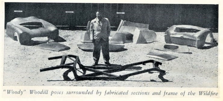 Robert "Woody" Woodill poses surrounded by fabricated sections and frame of the Wildfire